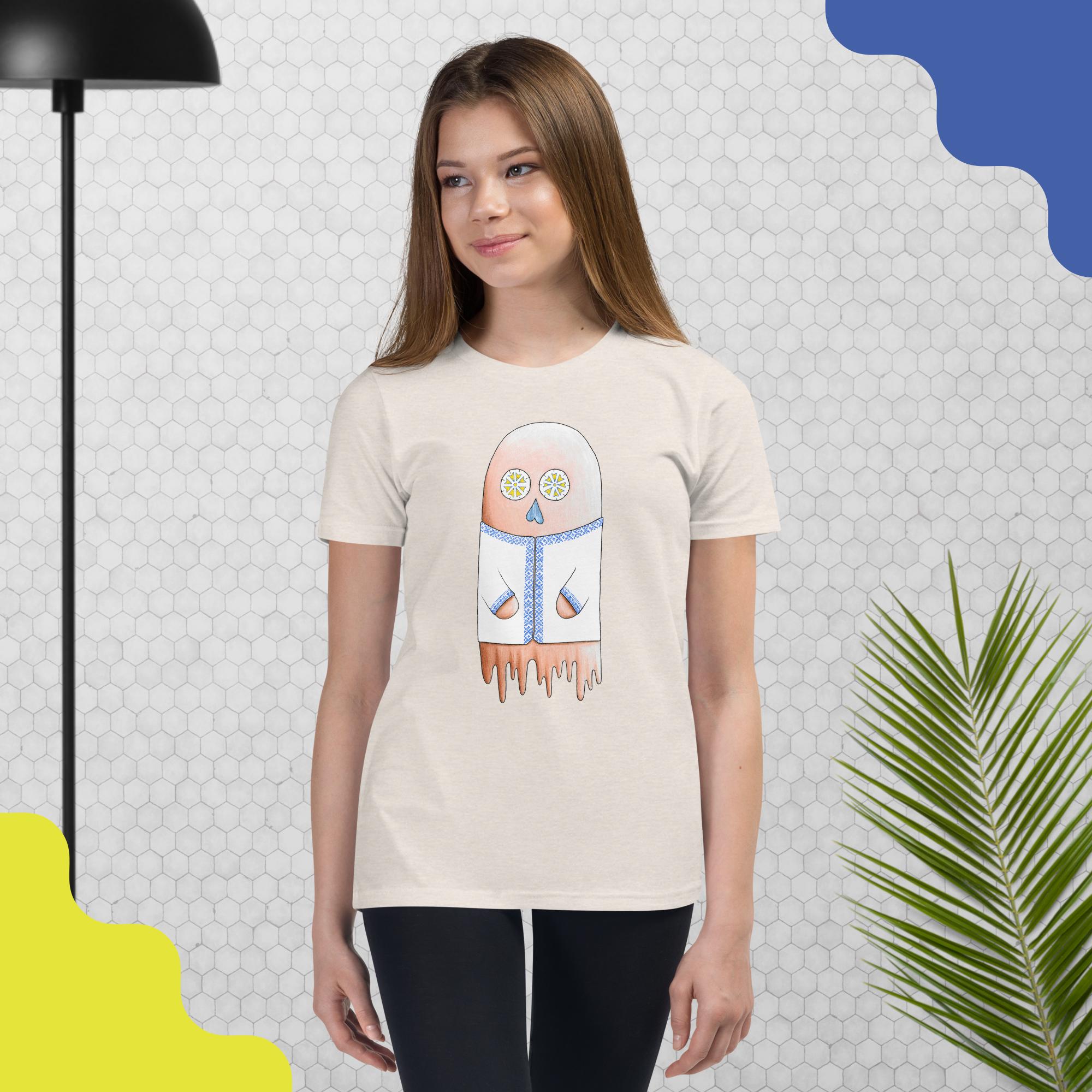 A child wearing a t-shirt with artwork of a ghost wearing a ukrainian-mexican style patterned shirt.